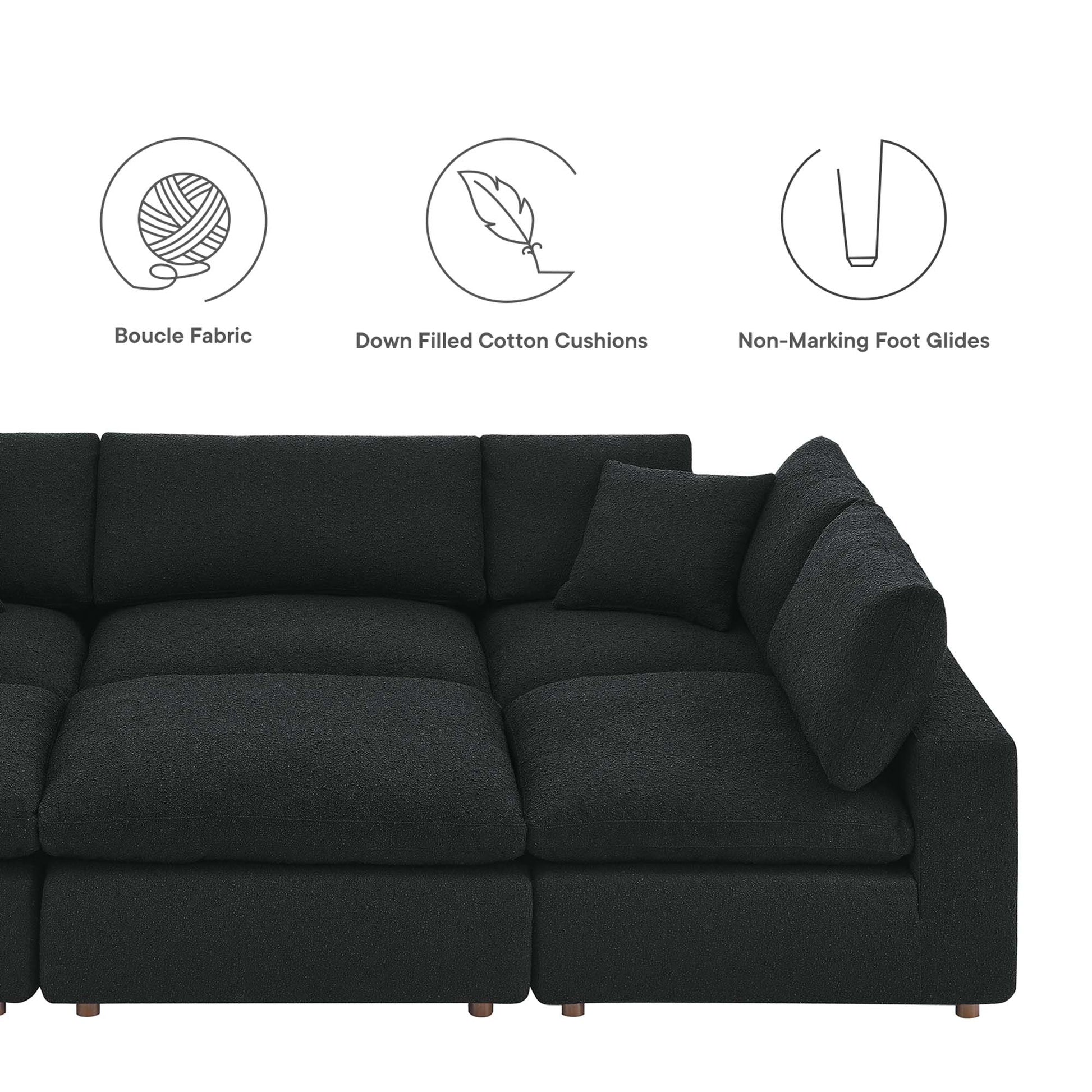 Charcoal fabric sectional sofa with plush cushions, low-profile arms and wooden legs; right-side chaise in an L-shape.