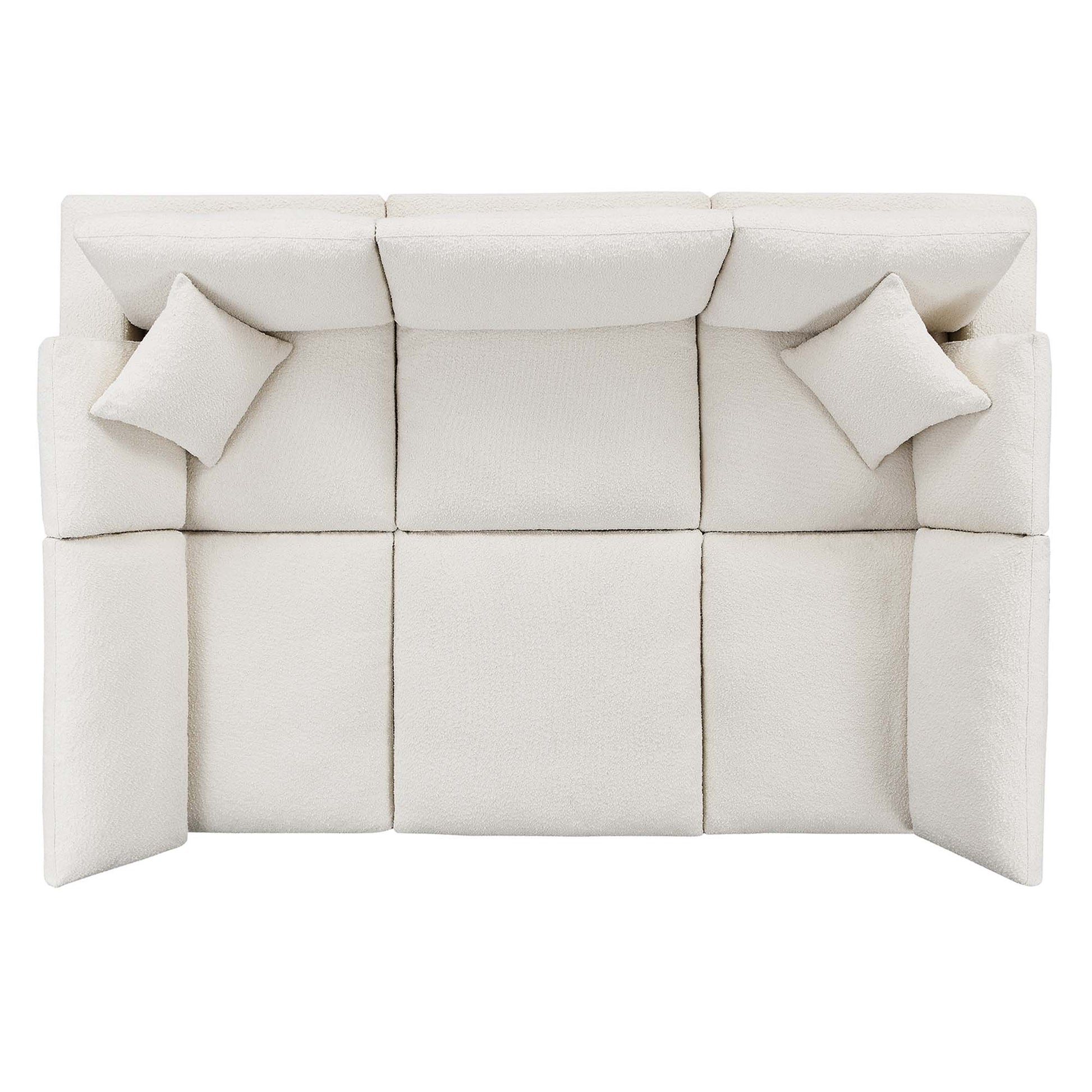 Ivory modular fabric sofa with three seat cushions, back cushions, and two square throw pillows, contemporary style.