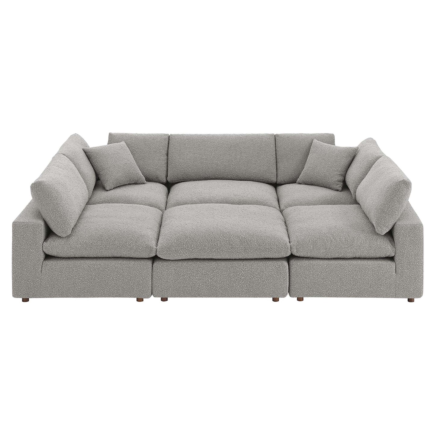 Light gray boucle fabric modular sectional sofa with multiple deep seat cushions and wooden legs.