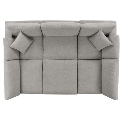 Light gray boucle fabric sectional sofa with two matching square throw pillows.