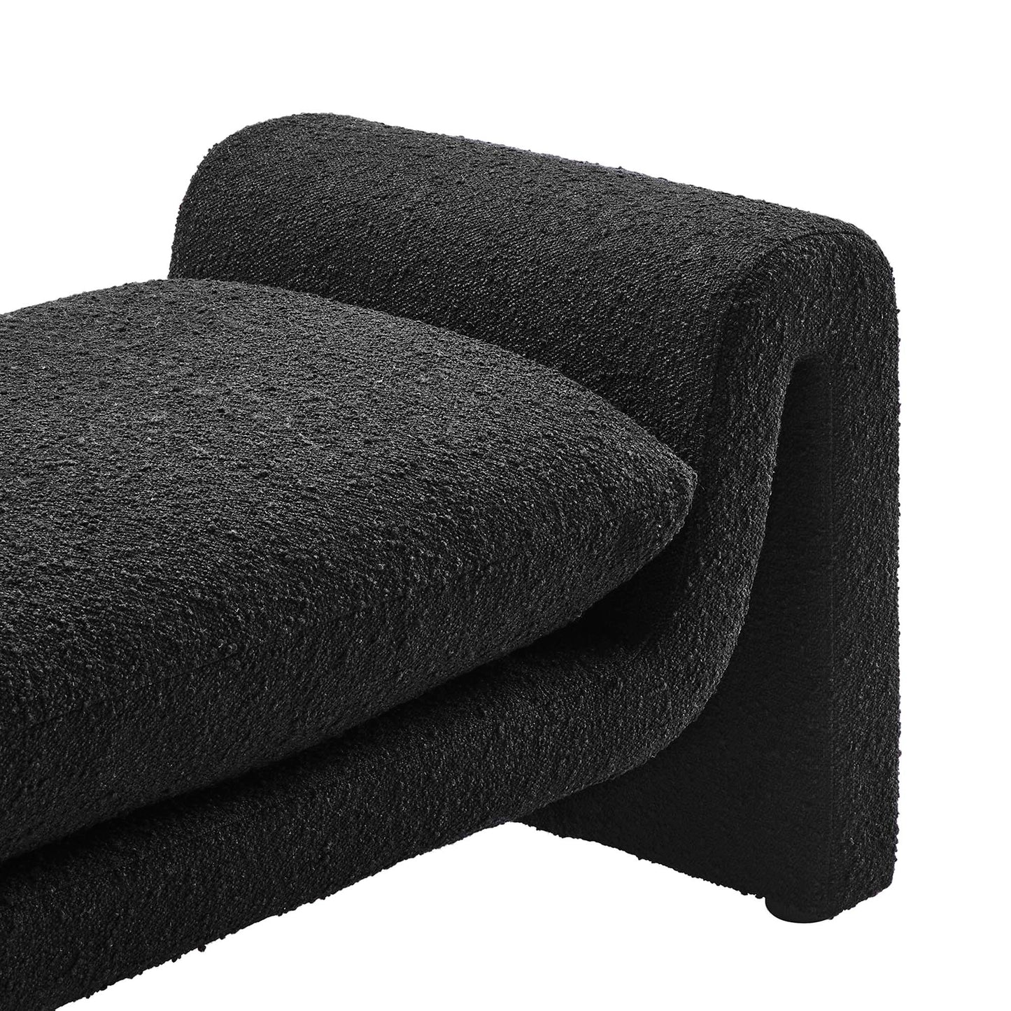 Black boucle fabric bench with a curved silhouette; modern living room seating.