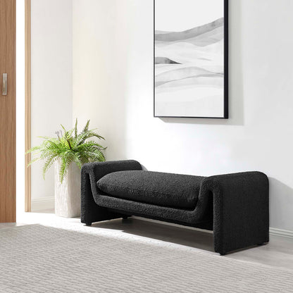 Charcoal black curved boucle fabric bench with wraparound arms in a modern entryway, with fern and abstract wall art.