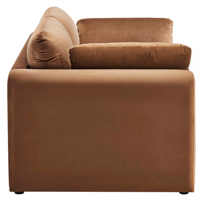 Brown velvet sofa with plush back and seat cushions and a boxy low-profile frame for casual living room use.