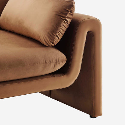 Brown velvet sofa arm with rounded edge and thick cushion, modern mid-century style.
