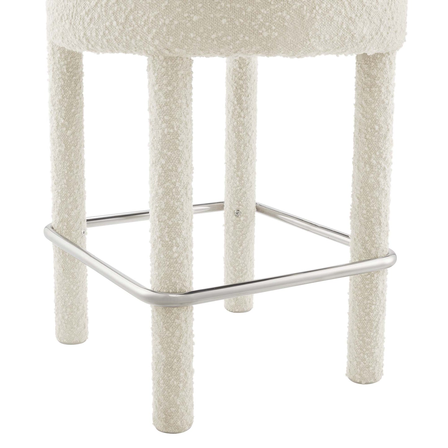 Silver boucle upholstered counter stool with four textured legs and chrome footrest.