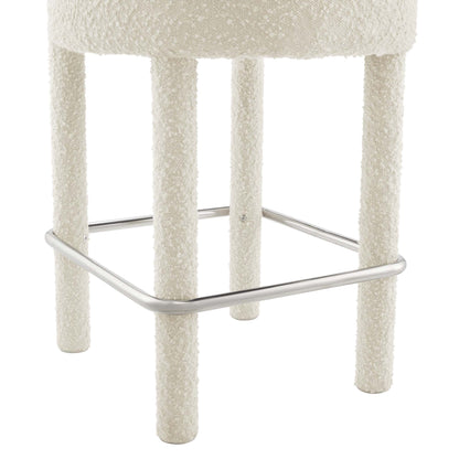Silver boucle upholstered counter stool with four textured legs and chrome footrest.