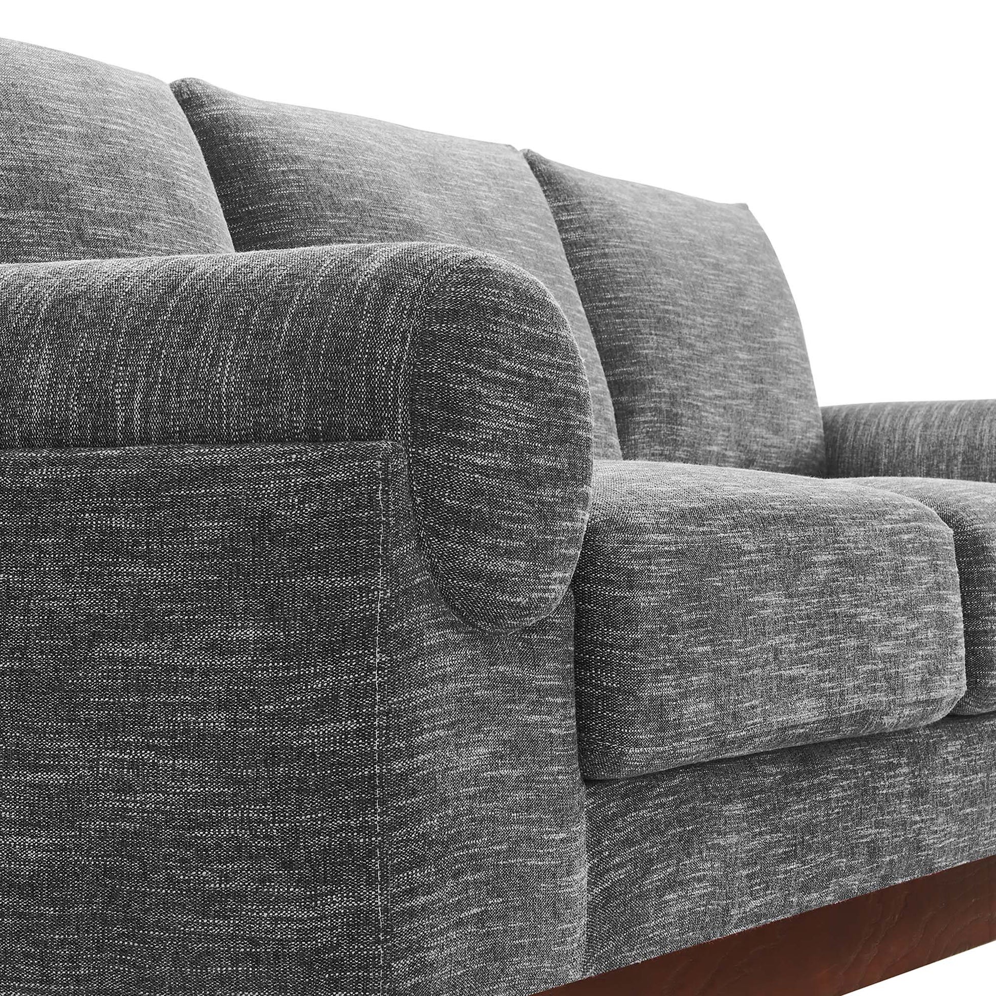 Gray textured fabric sofa with rounded arms, plush back cushions & a wooden base rail.