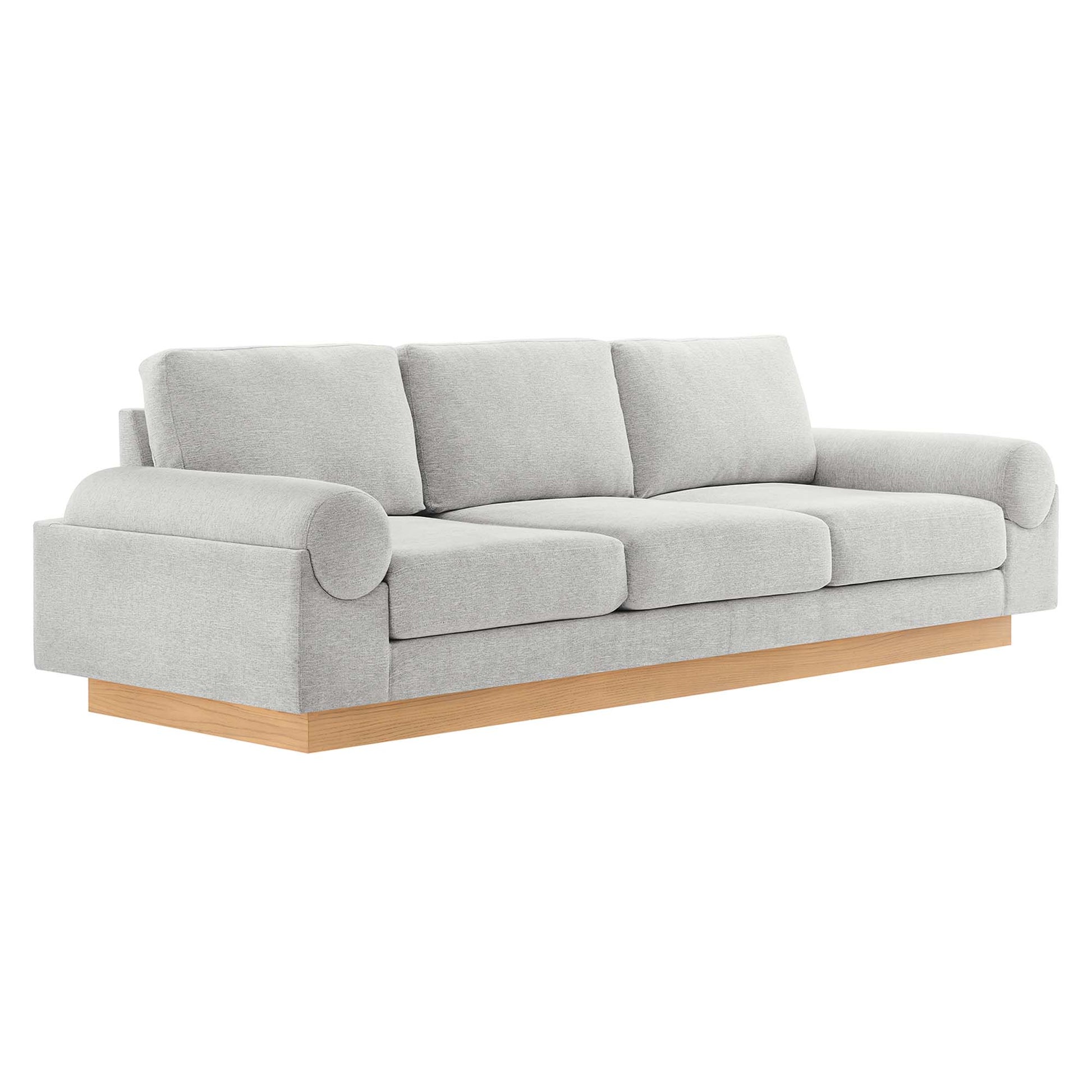 Light gray fabric sofa with three seat cushions, rounded rolled arms, and a natural wood platform base.