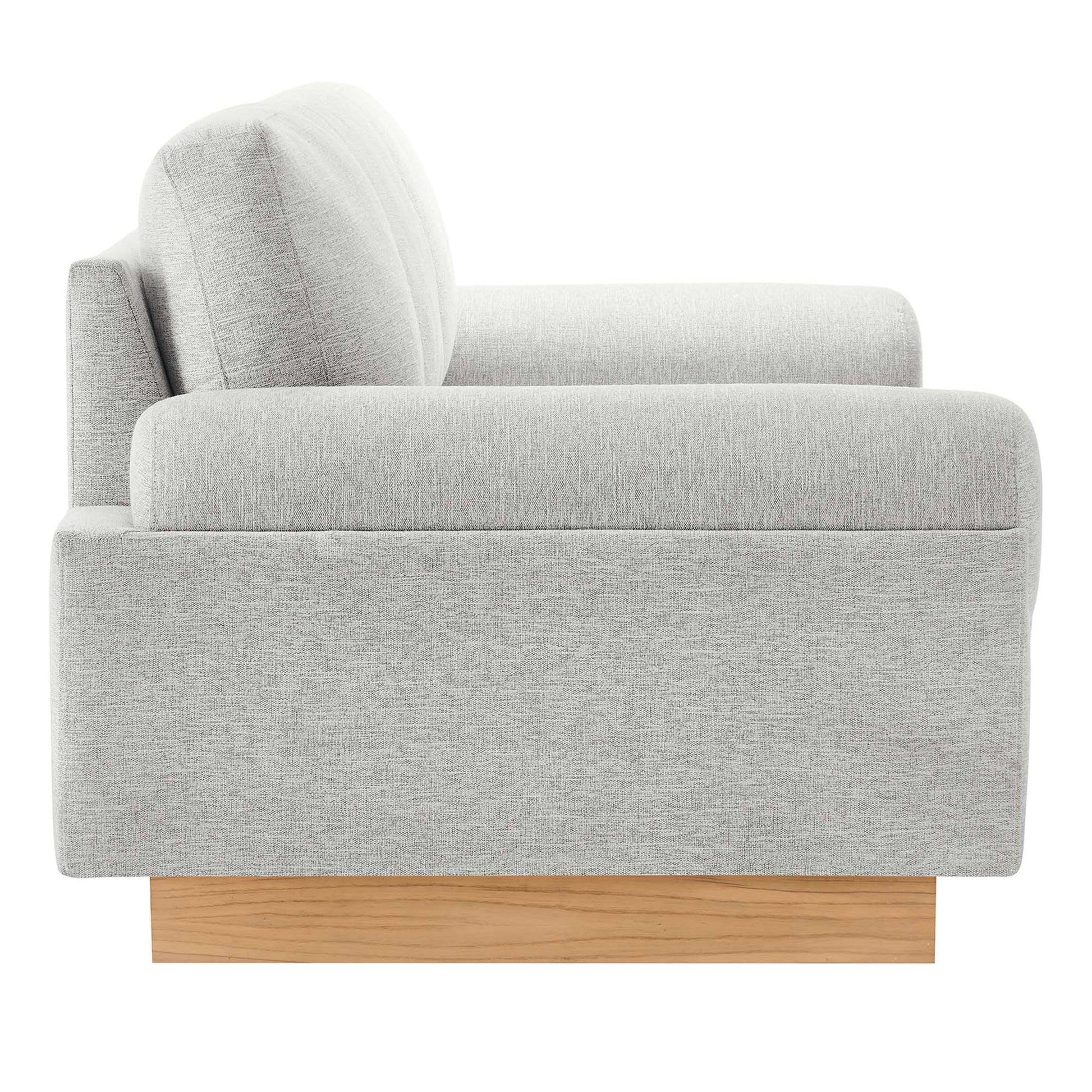 Light gray textured fabric sofa with rounded back cushions on a wooden block base, modern mid-century style.