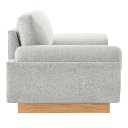 Light gray textured fabric sofa with rounded back cushions on a wooden block base, modern mid-century style.