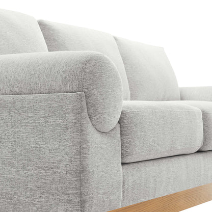 Light gray fabric sofa with rounded arms, plush cushions, and a wooden base rail.