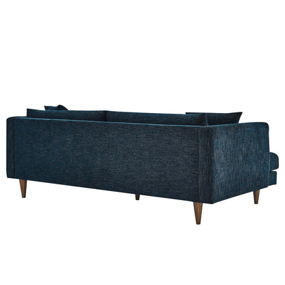 Navy blue textured fabric three-seat sofa with wooden tapered legs in a mid-century modern style.