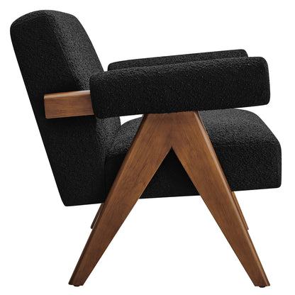 Mid-century black boucle fabric loveseat with wood-capped padded arms and angled warm wood legs.