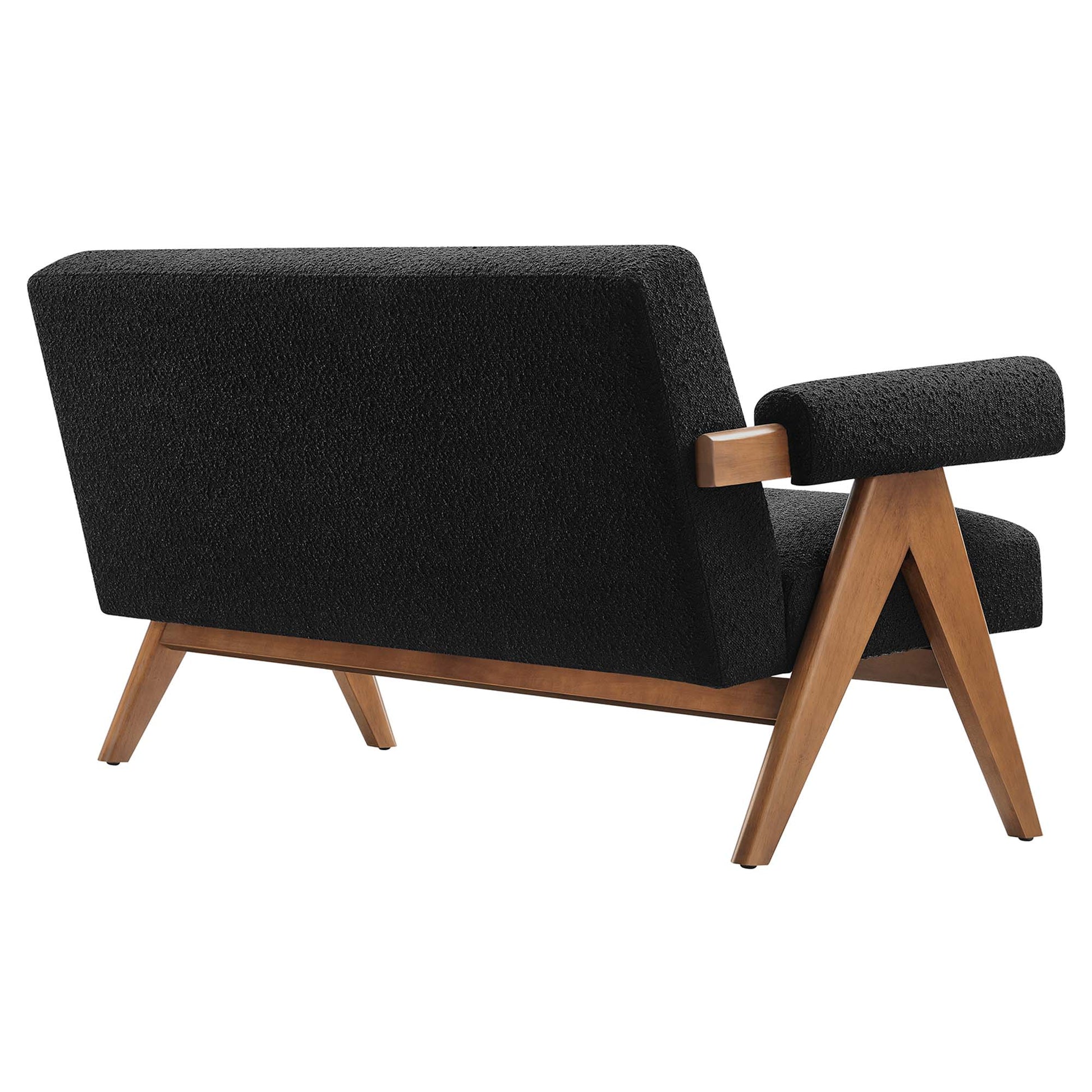 Mid-century black boucle loveseat with a wooden frame, angled legs & low-profile armrests.