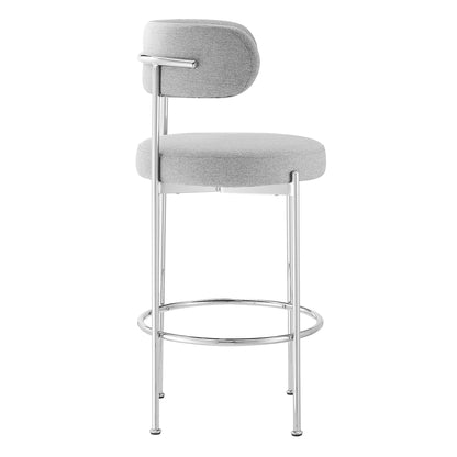 Grey fabric upholstered bar stools with chrome metal frames, rounded seats, small backrests, and circular footrests, set of 2.