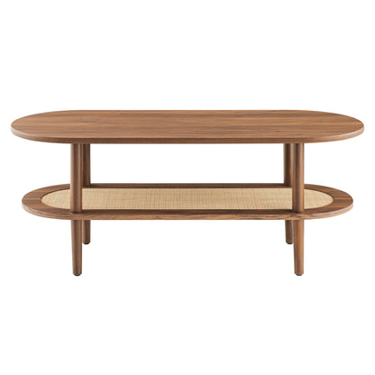 Walnut oval coffee table with two vertical supports and lower rattan-woven shelf, mid-century modern.
