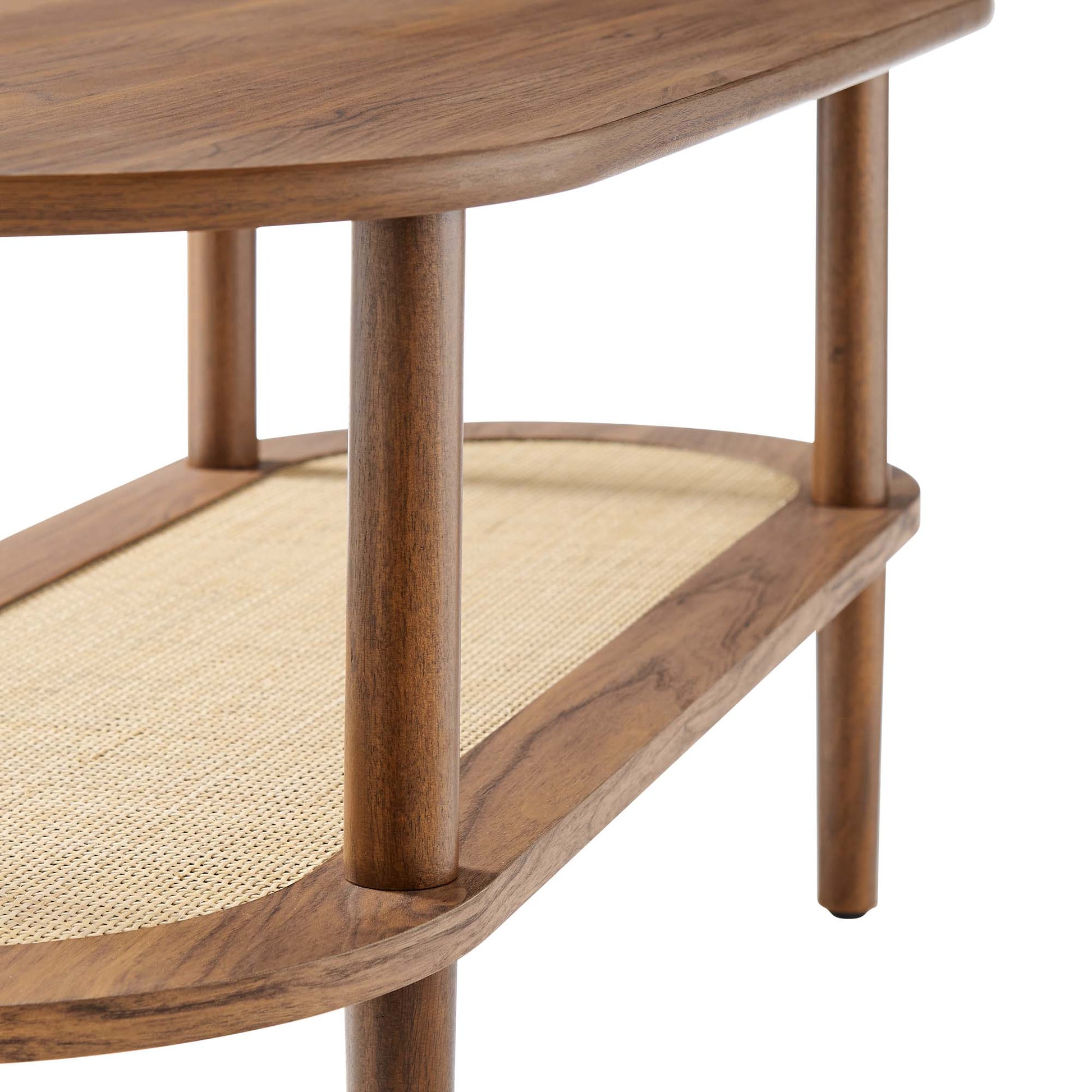 Brown oval coffee table with two tiers, a woven rattan lower shelf, and cylindrical legs.