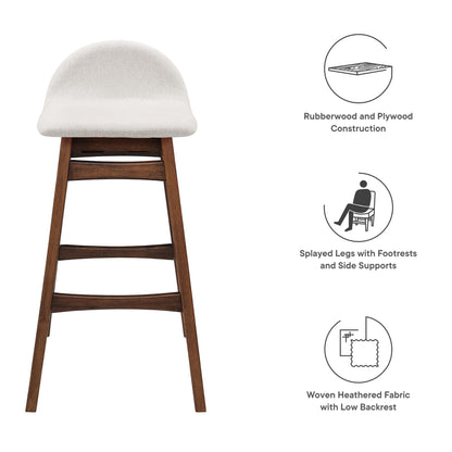 Bar stool in rubberwood with warm brown frame, ivory woven fabric cushion, low backrest, splayed legs and footrests.