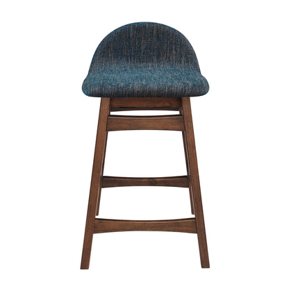 Wooden counter stool with dark brown legs and a blue textured upholstered rounded seat with footrest rails.