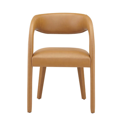 Tan vegan leather dining chair with curved back and wraparound arms, padded seat, four tapered legs.