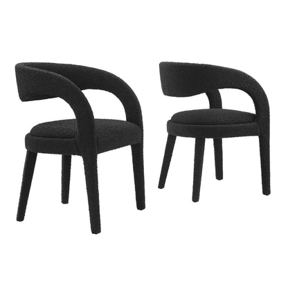 Pair of black boucle chairs with rounded back and loop arms, circular seats, slender legs.