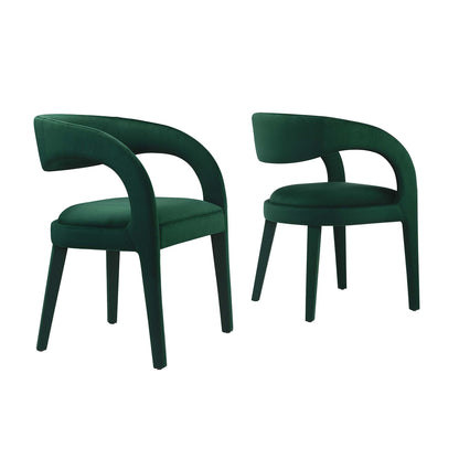 Pair of dark green velvet dining chairs with curved wraparound arms and tapered legs.
