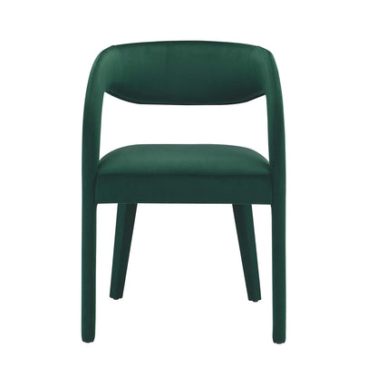 Emerald green velvet upholstered dining chair with rounded back and integrated arms, cushioned seat, modern design.
