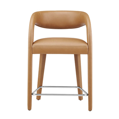 Tan vegan leather counter stools with curved backrests, cushioned seats, set of 2, with wooden legs & chrome footrests.