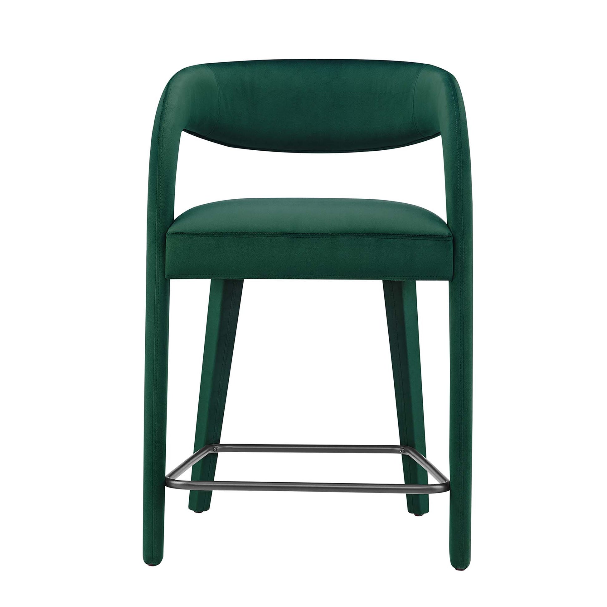 Emerald green velvet counter stool with curved back, padded seat, and chrome footrest.