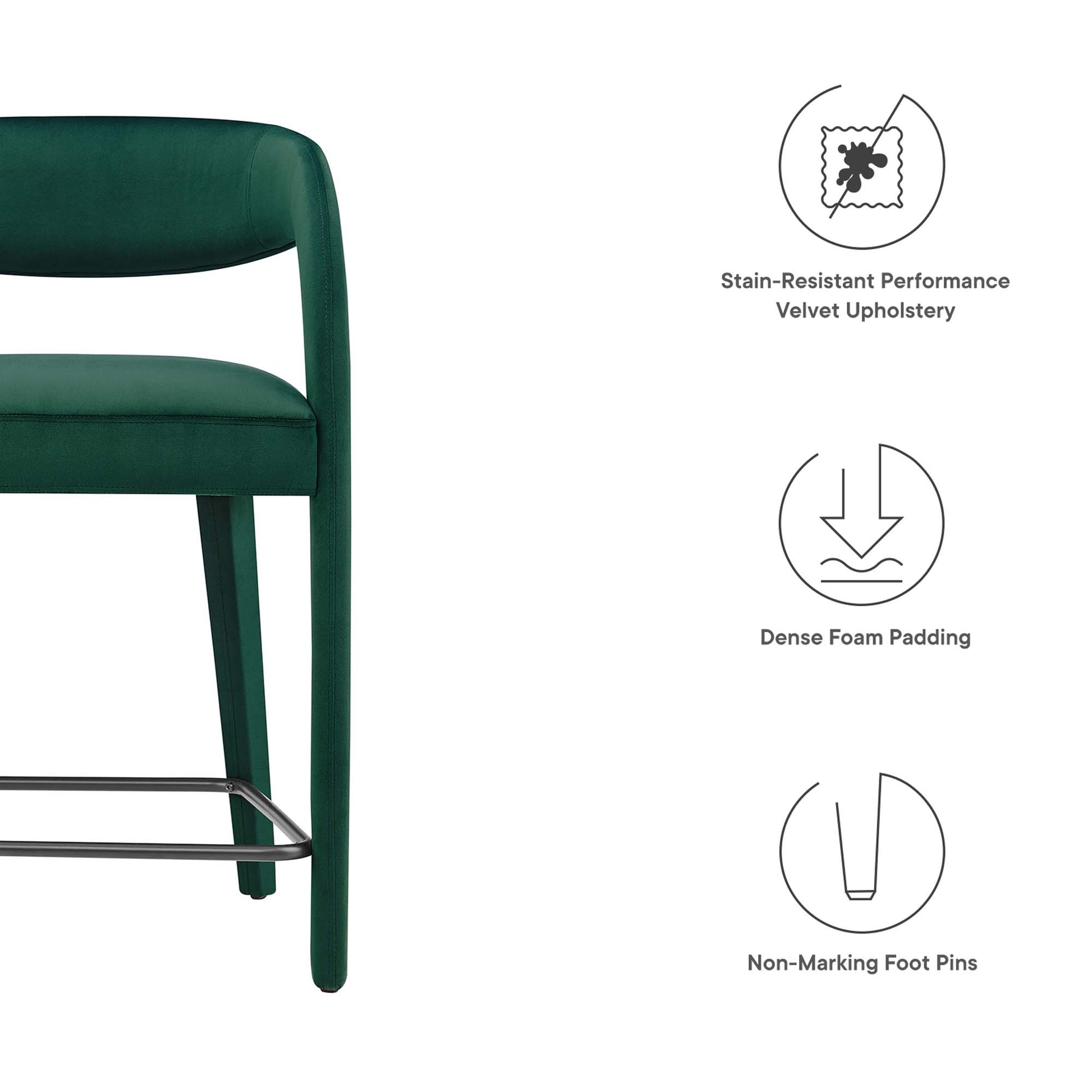 Emerald green velvet upholstered curved-back counter stool with chrome footrest and dense foam padding
