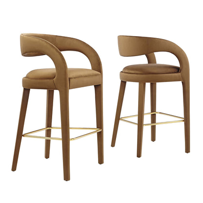 Pair of brown upholstered bar stools with curved backrests, integrated arms, and gold-tone footrests.
