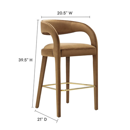 Yellow velvet upholstered bar stools with curved back, gold metal footrests, and wooden legs; 39.5H x 20.5W x 21D; set of 2