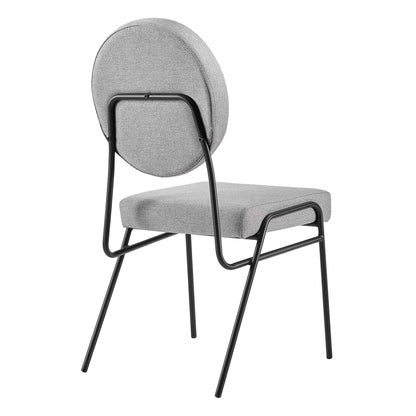 Gray upholstered chair with circular backrest and black metal frame; cushioned seat, modern dining/accent chair.