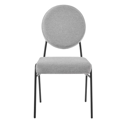 Pair of light gray upholstered dining side chairs with black metal legs in a modern minimalist design.