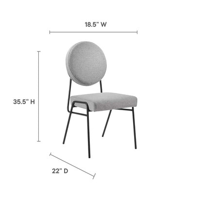Light gray upholstered dining chairs with a round back cushion on black metal legs; set of 2.