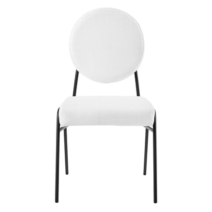 Pair of black upholstered fabric dining side chairs with round white back cushions and white padded seats, slim legs.