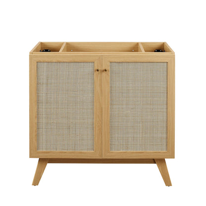 Oak bathroom vanity cabinet with two cane-panel doors and mid-century angled legs; brown oak finish, sink basin not included.