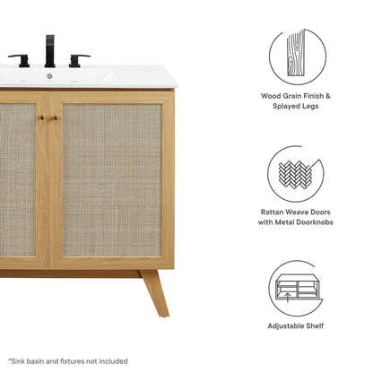 Oak bathroom vanity cabinet with rattan doors, wood grain finish, splayed legs, and adjustable shelf; sink basin not included.