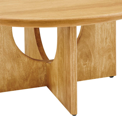 Light oak round coffee table with curved cut-out side supports & solid rectangular legs.
