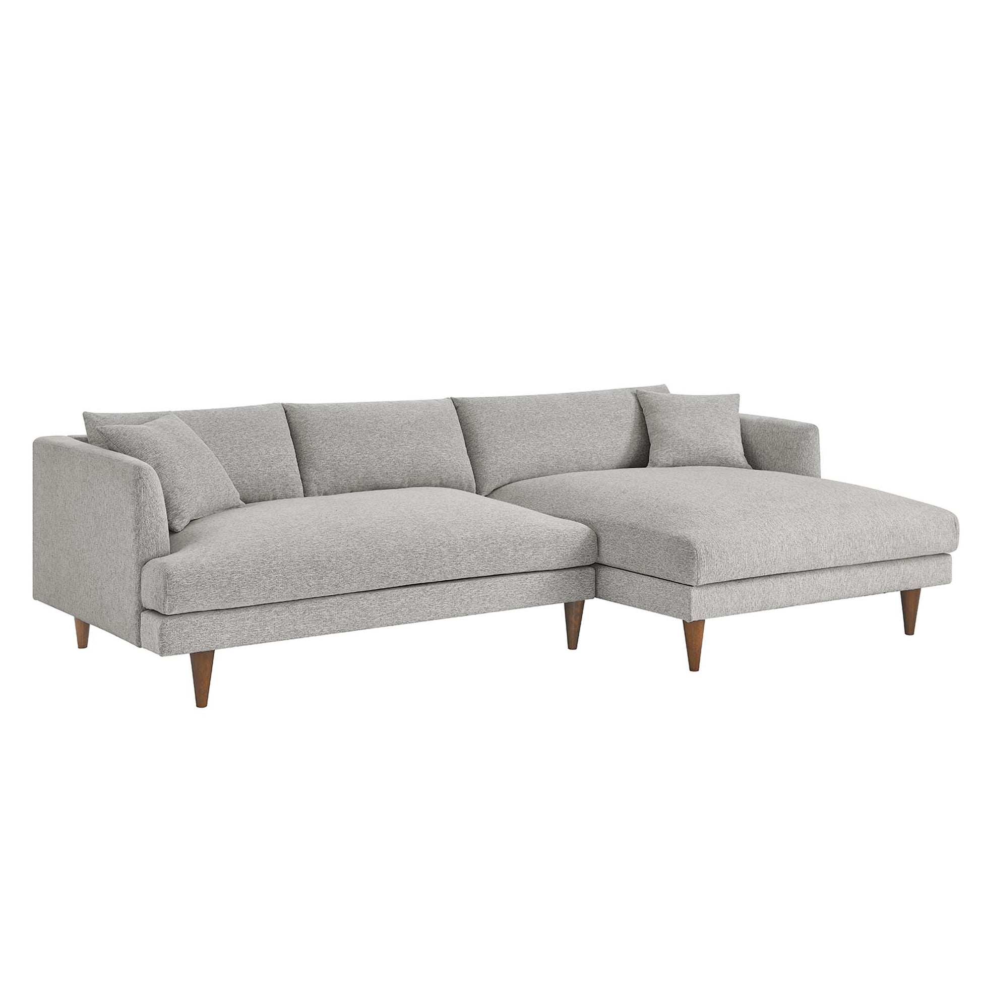 Light gray fabric sectional with right-side chaise, mid-century wooden legs, plush back cushions.