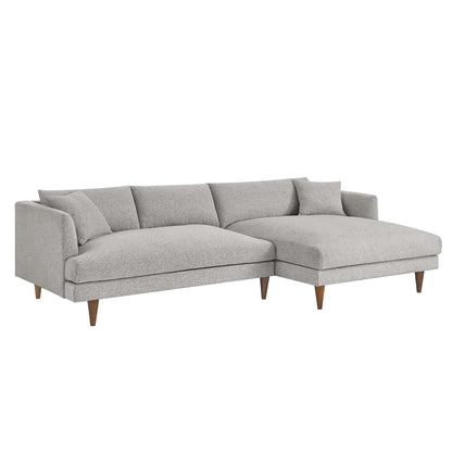 Light gray fabric sectional with right-side chaise, mid-century wooden legs, plush back cushions.