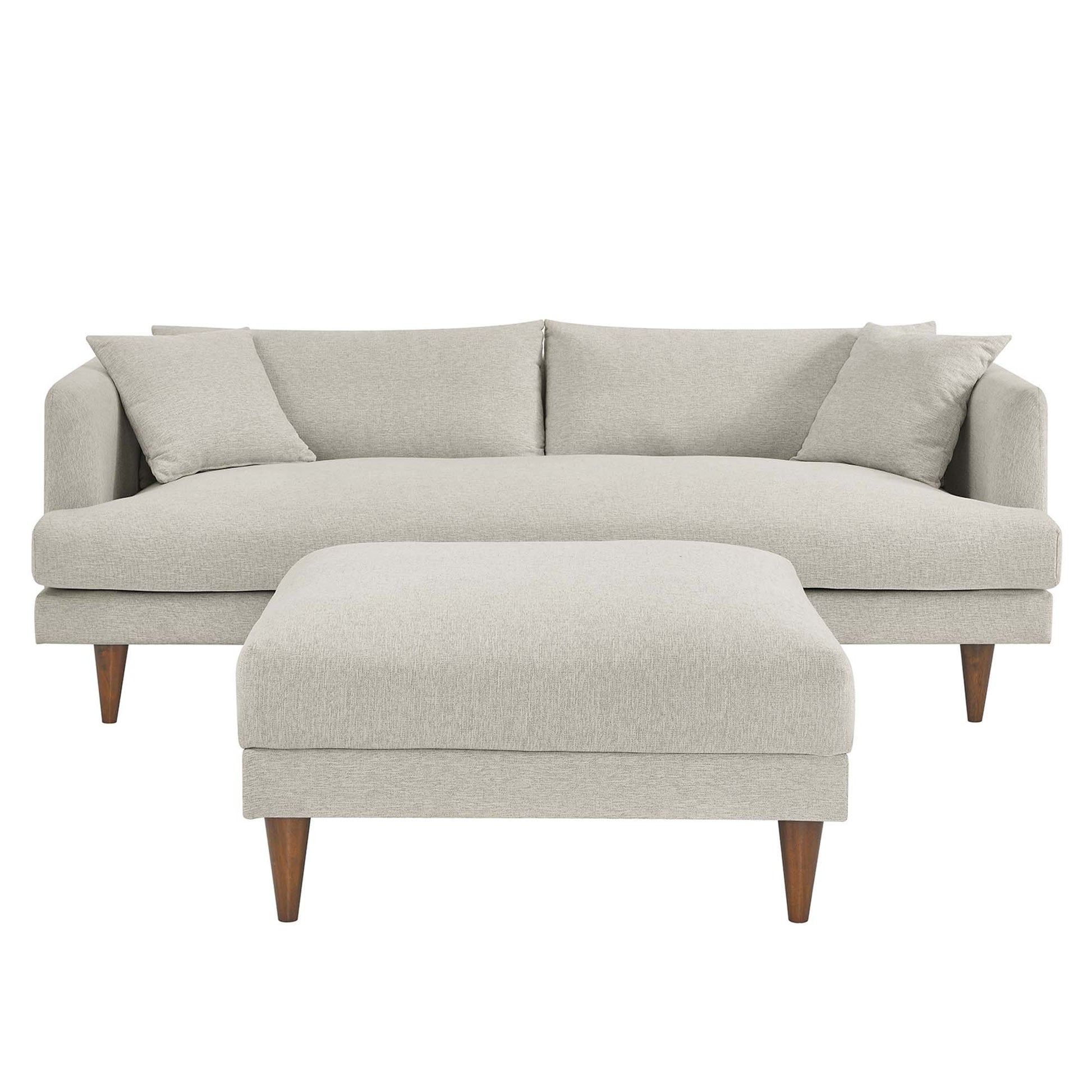 White textured fabric sofa & matching ottoman with tapered wooden legs in a mid-century modern style.