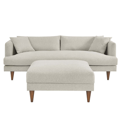 White textured fabric sofa & matching ottoman with tapered wooden legs in a mid-century modern style.