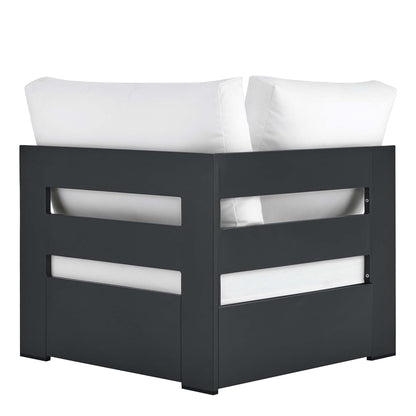Dark gray outdoor modular corner chair with white cushions and horizontal side cutouts.