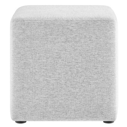 Light gray fabric upholstered cube ottoman with rounded corners and small black feet.