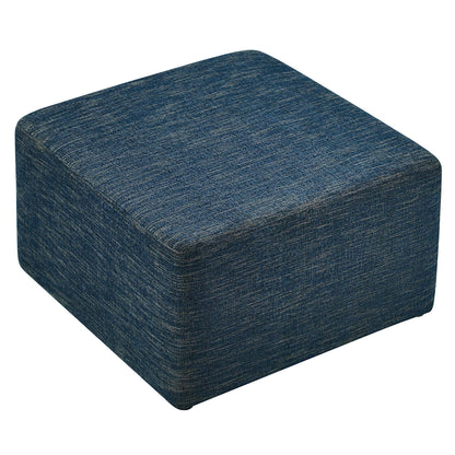 Blue woven fabric cube ottoman with rounded edges; compact pouf-style footstool for living room decor.