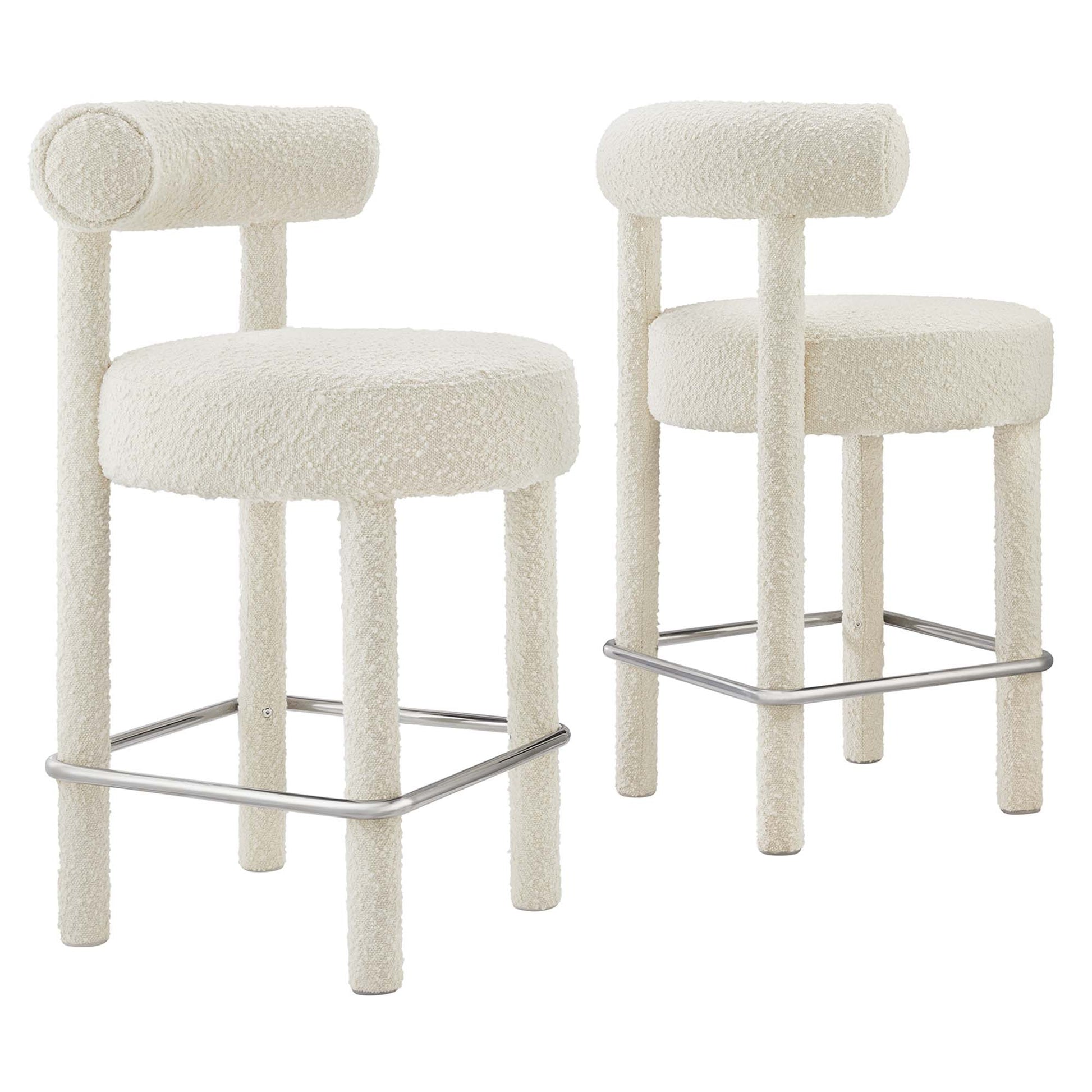 Pair of silver boucle counter stools with round padded seats, cylindrical backrests, and chrome footrests.