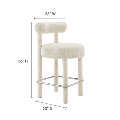 Ivory boucle counter stool with round padded seat, cylindrical backrest, four upholstered legs, chrome footrest.