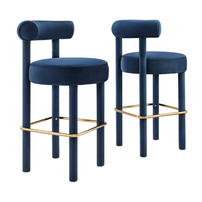 Pair of navy blue velvet bar stools with round seats, cylindrical backrests, blue legs and gold foot rails