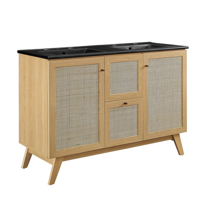 Oak finish cabinet with black top and dual sinks, woven rattan panel doors, central drawers, mid-century modern style.